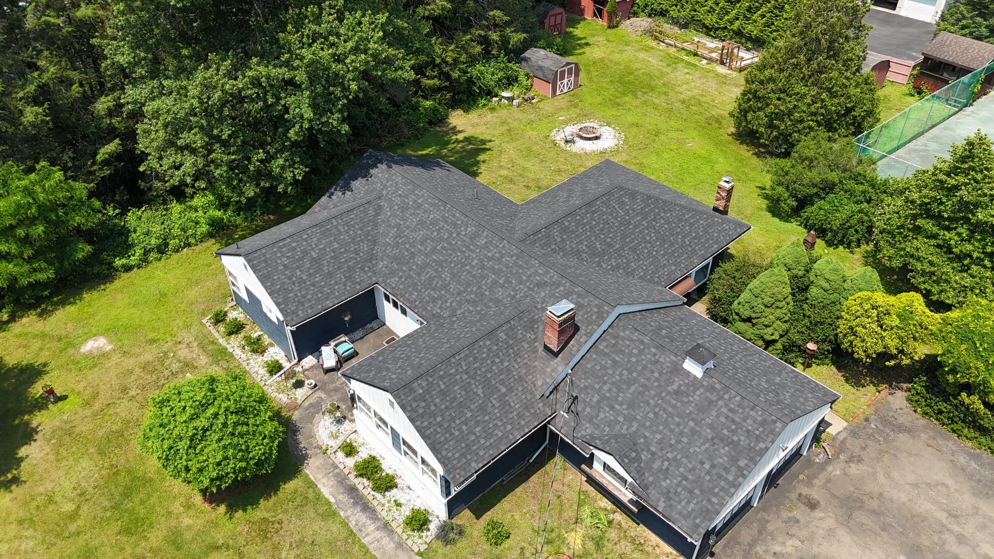 Aerial view of a gray shingle roof replacement on a ranch home in Cornwall, NY
